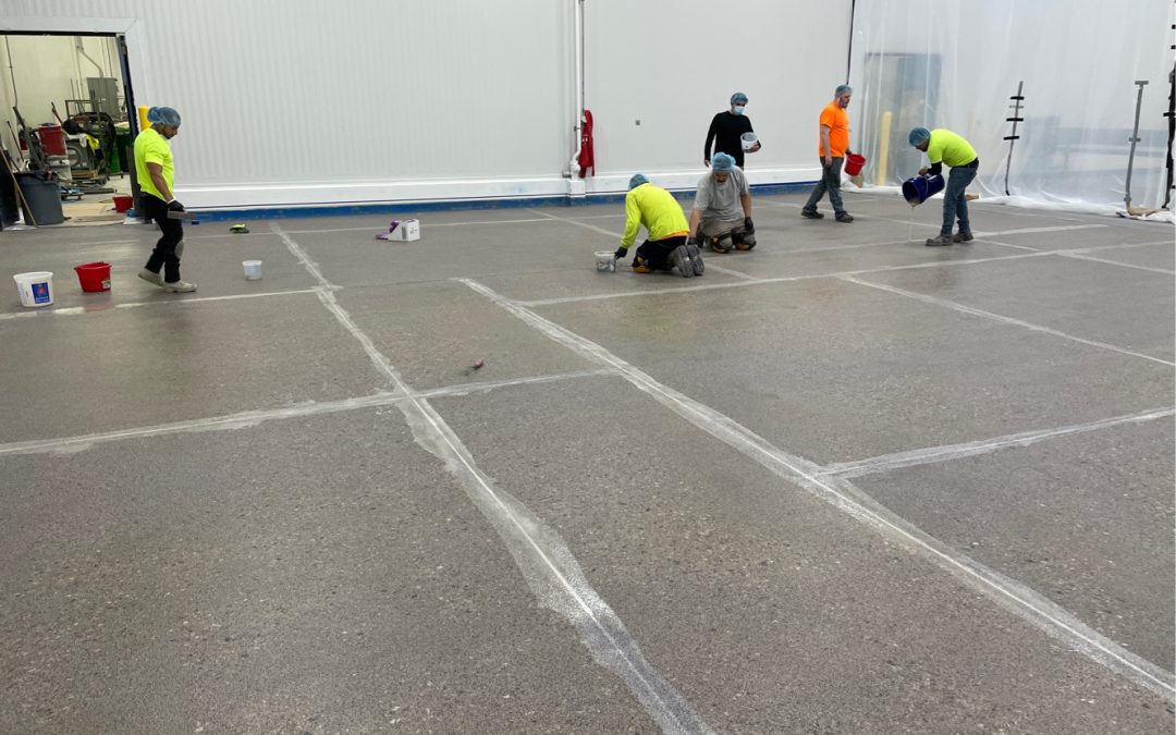 Floor Coatings installation team patching joints and making seamless flooring system