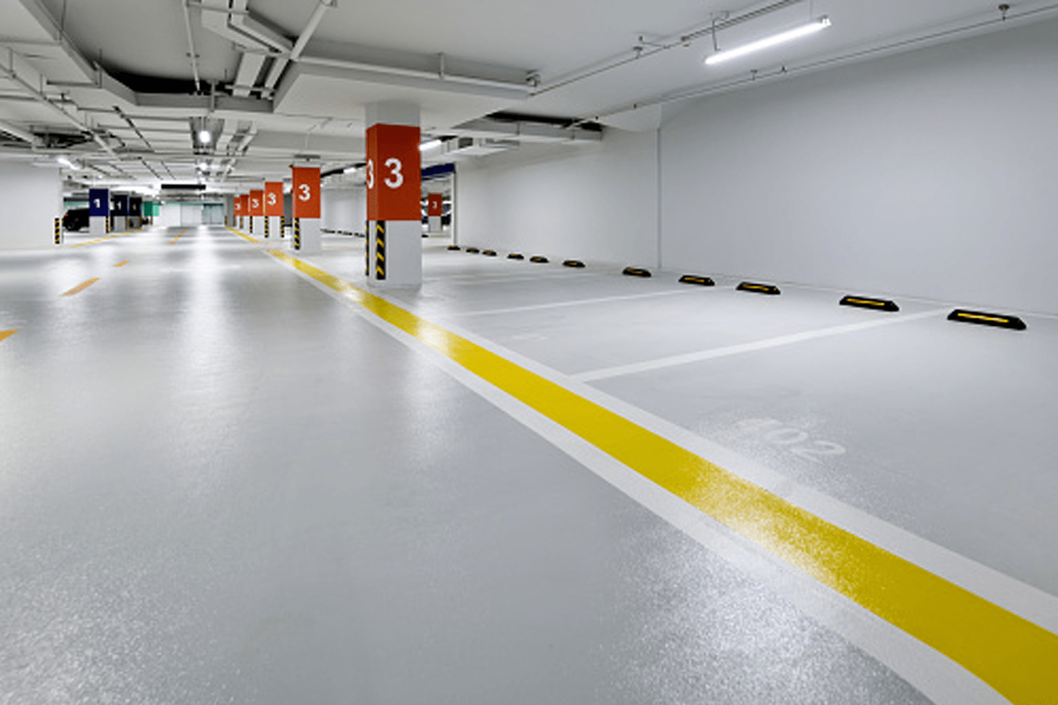 traffic and parking deck floor coatings with quartz broadcast and striping and numbering of parking spaces